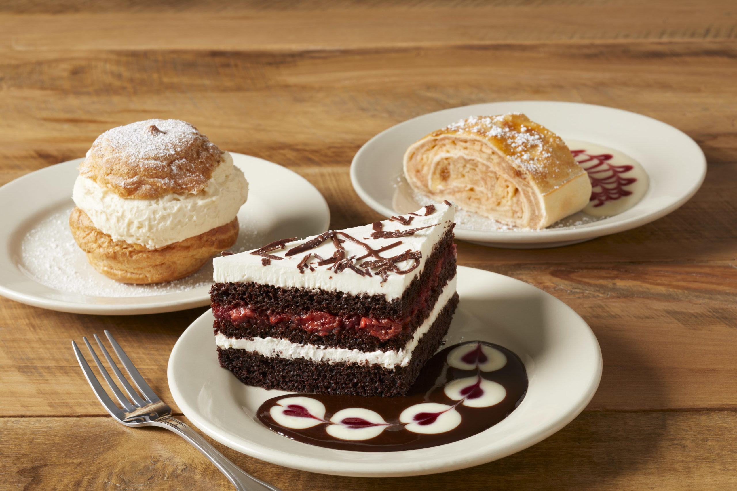 cream puff and chocolate cake on white plate