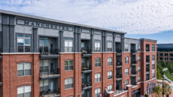 Aerial photo of apartment building with Manchester lettering on top floor